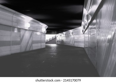 Underground pedestrian crossing. A dark path to light. Geometry of architecture. Shades of gray