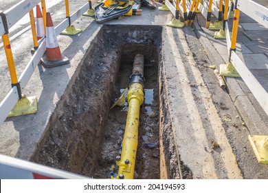 Underground pipe being fixed in trench