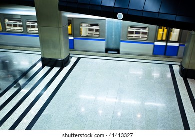 Underground platform interior with move train and crowd