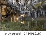 Underground pool with calm reflections with stalactites hanging from the ceiling inside the Lehman Caves in Great Basin National Park