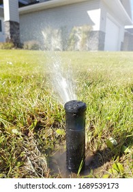 Underground Sprinkler misting in Lawn. - Shutterstock ID 1689539173