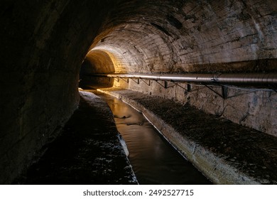 Underground vaulted urban sewer tunnel with dirty sewage. - Powered by Shutterstock