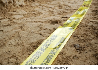 Underground Warning Tape Placed On The Sand To Alert The Underground Power Lines In The Chemical Plant Construction Project.