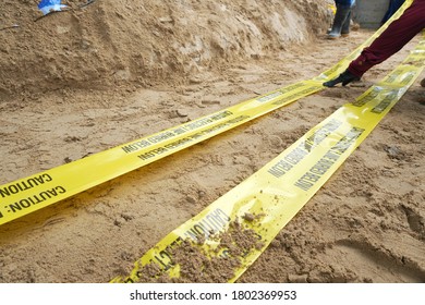 Underground Warning Tape Placed On The Sand To Alert The Underground Power Lines In The Chemical Plant Construction Project.