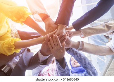 Underneath view, Business teamwork groups people hands, stacked huddle together, unity international. - Shutterstock ID 541680640