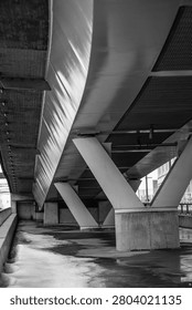 Underneath view of elevated bridge structure with concrete supports