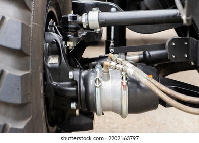 Underneath View Of A Semi Truck Or Trailer Rear Axle With The Suspension, Brake Cylinder Pod Pneumatic System Close Up View.