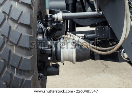 Underneath View of a Semi Truck or Trailer Rear Axle with the Suspension, Brake Cylinder Pod pneumatic system Close up View. Mud truck chassis frame suspension with wheel and arms with silent blocks