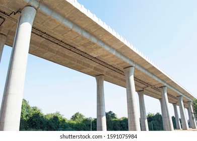Underside of an elevated roads. Transport interchange under the sky background. High overpass on the sky background