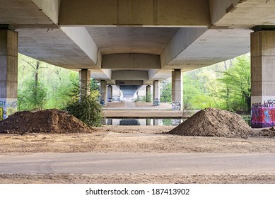 Underside image of a bridge with graffiti on the concrete supports in Germany