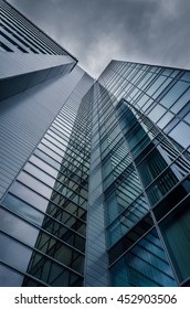 underside panoramic and perspective view to steel blue glass high rise building with reflections, skyscrapers, industrial architecture