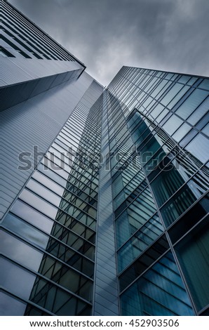 underside panoramic and perspective view to steel blue glass high rise building with reflections, skyscrapers, industrial architecture