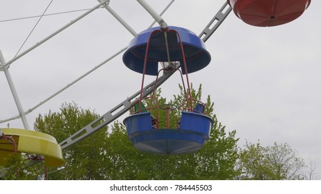 Underside view of a ferris wheel over blue sky
