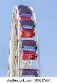 Underside view of a ferris wheel rotating downward 