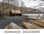 Underside view of several canoes in a row at boat house in Sierra mountains, California during wintertime.