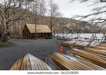 Underside view of several canoes in a row at boat house in Sierra mountains, California during wintertime.