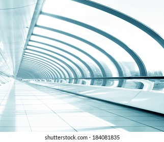 Underside wide angled and perspective view to steel blue glass airport ceiling through high rise building skyscrapers, business concept of successful industrial hallway and passageway architecture - Powered by Shutterstock