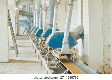 Under-silo conveyor system efficiently transports wheat for grain distribution in processing facility
