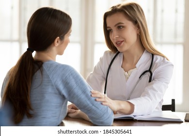 Understanding caring female doctor medical practitioner supporting comforting worried anxious young woman patient client of hospital, giving hope on good cure result, persuading in treatment success - Shutterstock ID 1845305641