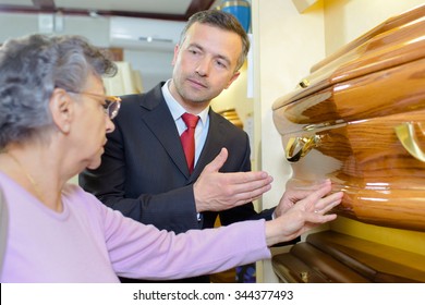 Undertaker Showing A Woman A Coffin