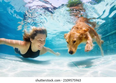 Underwater Action. Young Woman Play With Fun, Training Golden Retriever Puppy In Swimming Pool - Jump And Dive. Active Water Games With Family Pet, Popular Dog Breed Like Companion On Summer Vacation