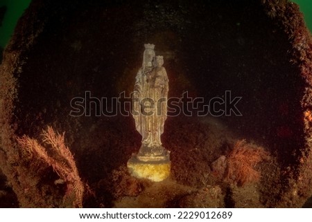 An underwater attraction off the coast of Marbella for scuba divers. The statue of the Madonna virgin Mary holding baby Jesus has been placed there