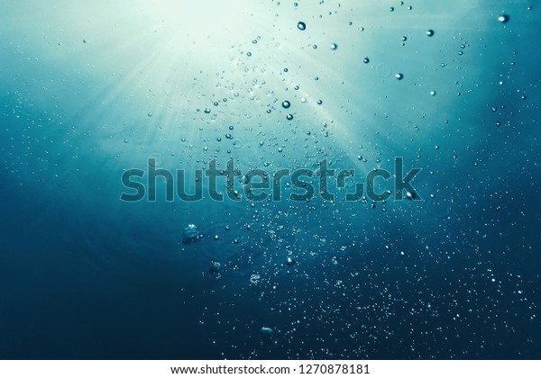 Underwater bubbles with sunlight. Underwater\
background bubbles.