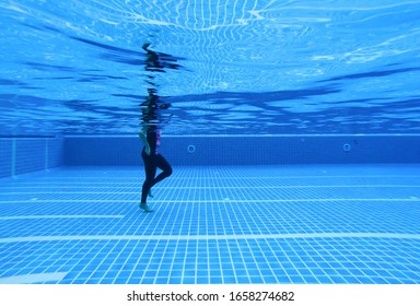 Underwater image of a woman walking in a swimming pool for treatment. underwater background - Powered by Shutterstock