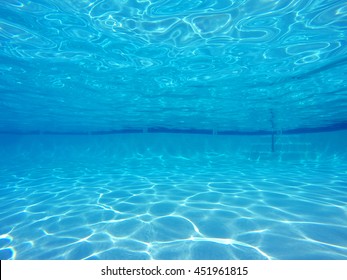 Underwater light patterns in clean empty suburban swimming pool.