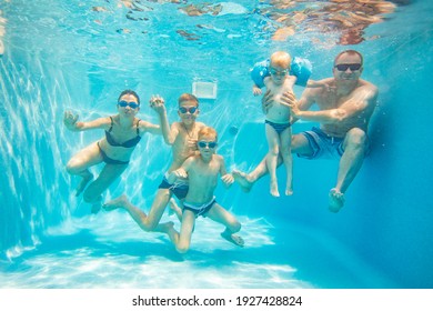 Underwater Photo Of Big  Young Family With Kids In Swimming  Pool