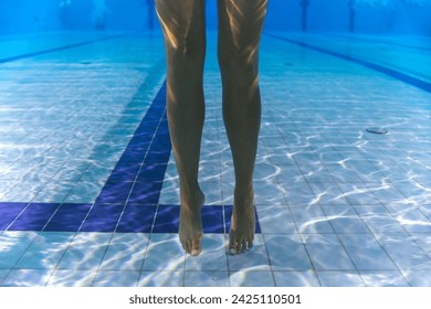 Underwater photo, legs of a slender girl underwater in a sports pool. High quality photo - Powered by Shutterstock