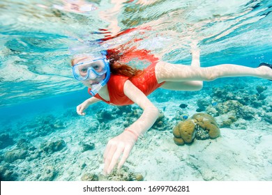 Underwater photo of a little girl swimming and snorkeling in tropical ocean - Powered by Shutterstock