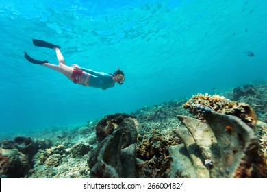 Underwater Photo Of Woman Snorkeling And Free Diving In A Clear Tropical Water At Coral Reef With Giant Clams