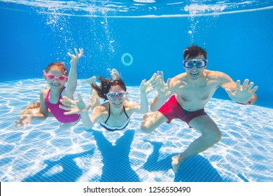 Underwater Photo Of Young Family With Kids In Swimming  Pool