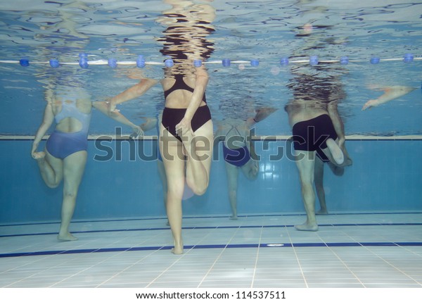 Underwater picture of an\
aerobics class.