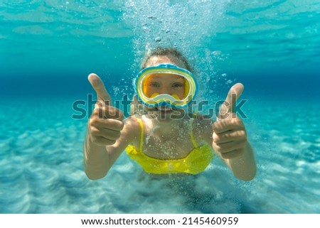 Underwater portrait of child. Kid having fun in the sea. Summer vacation and healthy lifestyle concept