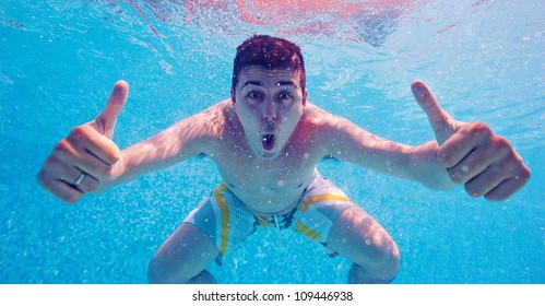 Underwater portrait of happy man in swimming pool. - Powered by Shutterstock