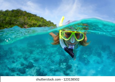 Underwater Portrait Of A Woman Snorkeling In Tropical Sea.