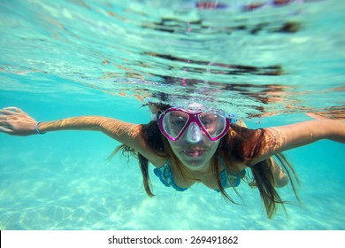 Underwater Portrait Of A Yong Woman Snorkeling In Ocean.