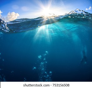 Underwater Scenery, Deep Blue Water Of The Ocean, Air Bubbles, Waterline Splitting Skyline, Divers Discovering Sea