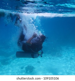 Underwater Shoot Of A Diver Doing Back Flip From A Boat