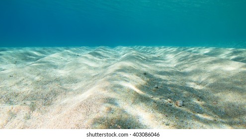 Underwater shot of the sea sandy bottom at sunny day 
