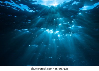 Underwater Shot With Sun Rays In Deep Blue Tropical Sea