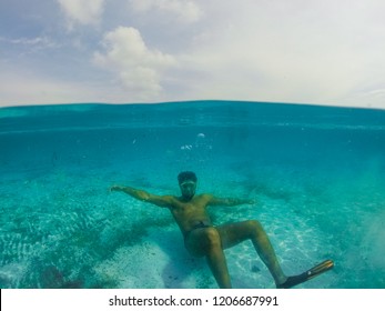 Underwater Split Screen View Of Man Diving Apnea.