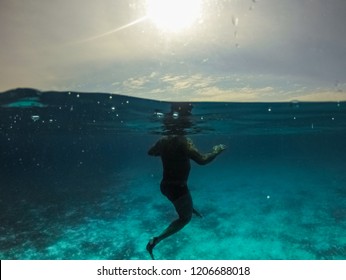 Underwater Split Screen View Of Man Diving Apnea.