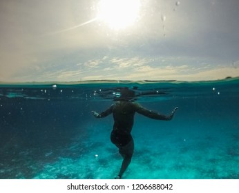 Underwater Split Screen View Of Man Diving Apnea.