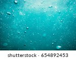 Underwater turquoise texture in ocean. Bubbles in tropical sea. 