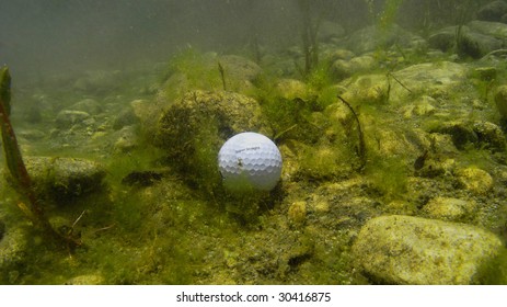 Underwater View Of A Golf Ball In A Water Hazard.