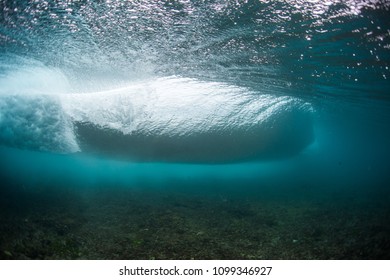 Underwater view of an ocean wave breaking over coral reef - Powered by Shutterstock