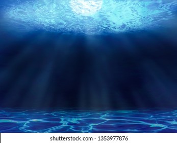 Underwater view with a sea surface, seabed and sun rays - Shutterstock ID 1353977876
